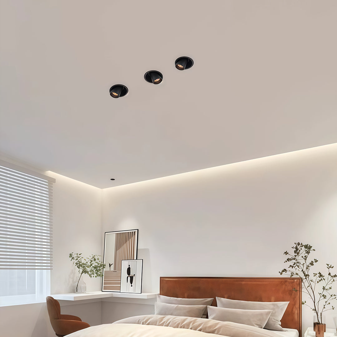 Architectural adjustable LED ceiling spotlights with glass shade chandelier influence providing dramatic illumination for pink canvas art.