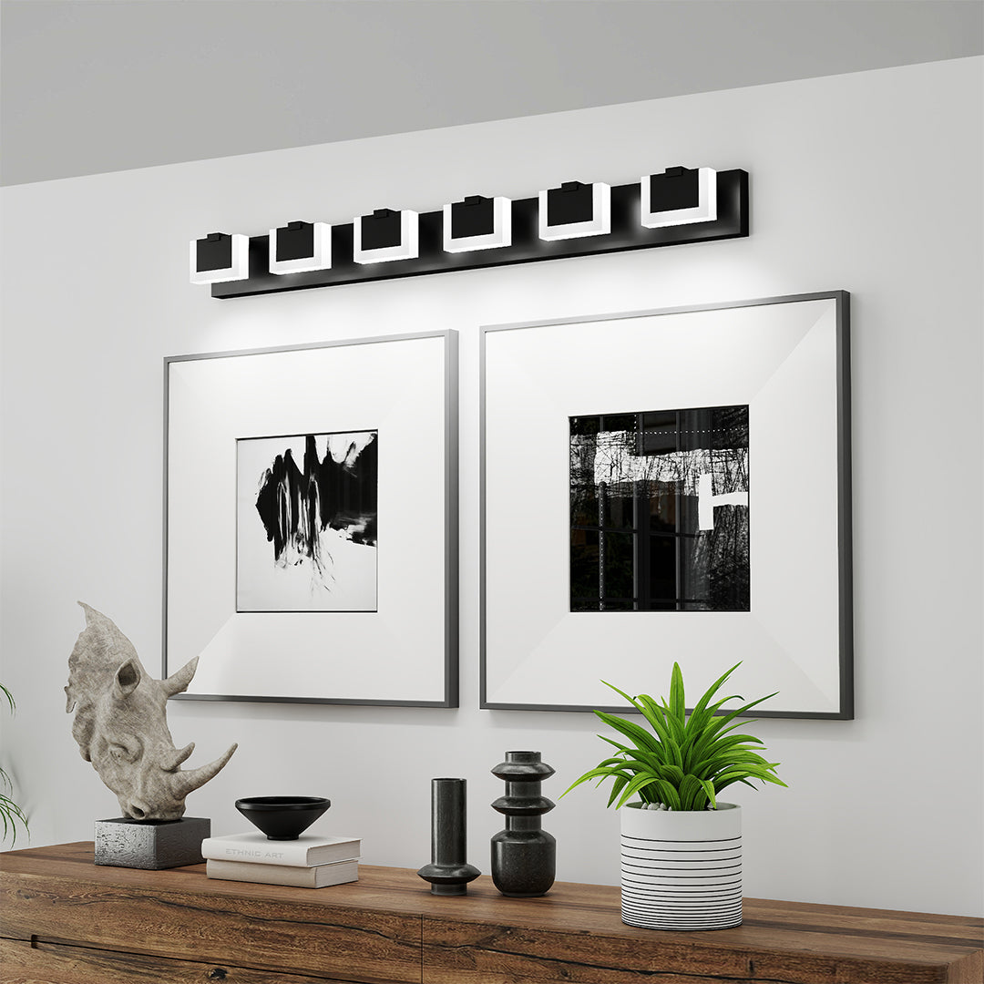 Architectural bathroom LED vanity lights with glass shade chandelier styling creating gallery atmosphere with framed artwork.