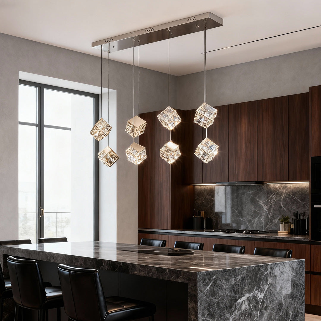 Architectural chandelier with crystals and glass shade chandelier design creating dramatic statement in modern kitchen with marble island.