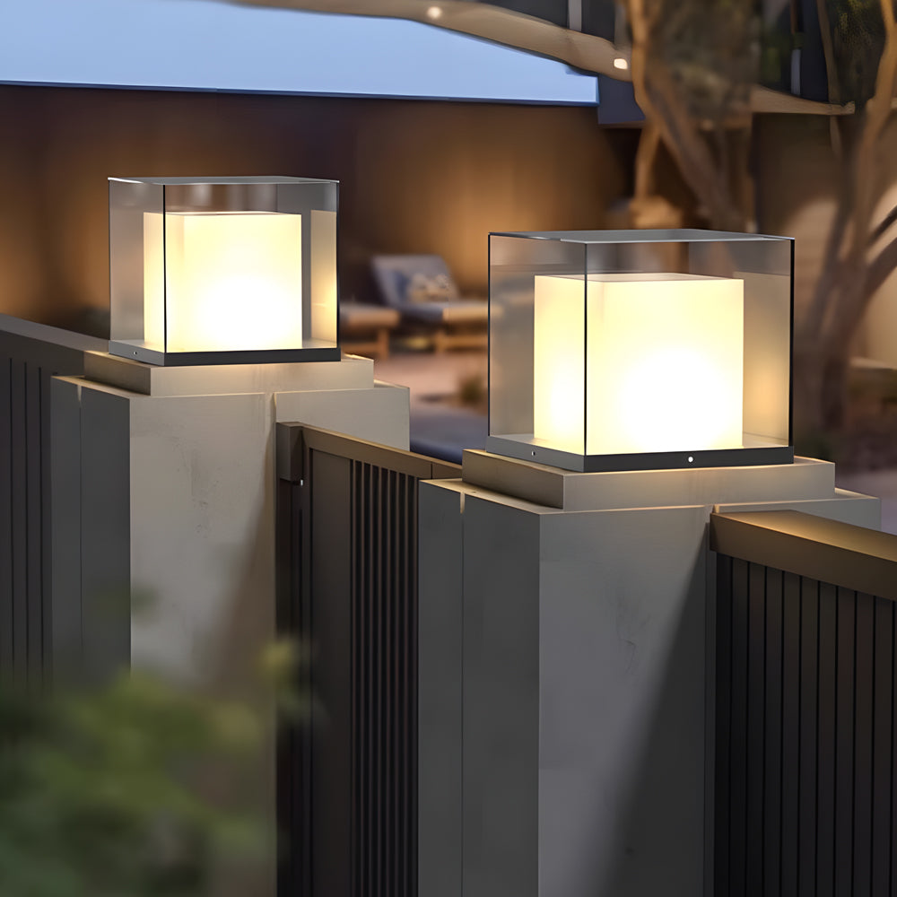 Architectural gate pillar lights installed on concrete posts providing ambient outdoor lighting