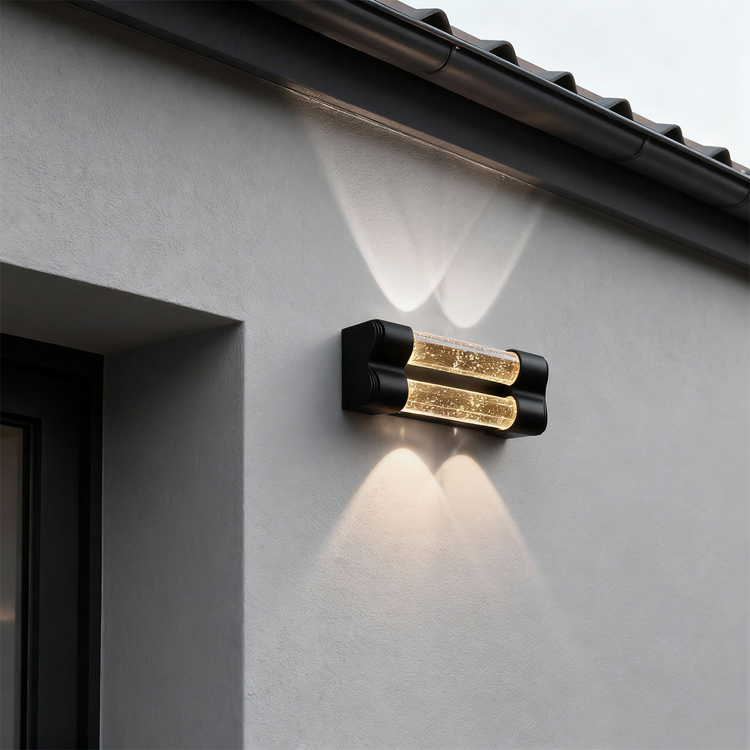 Architectural crystal wall sconce light fixture featuring glass shade chandelier styling providing ambient exterior illumination at dusk.