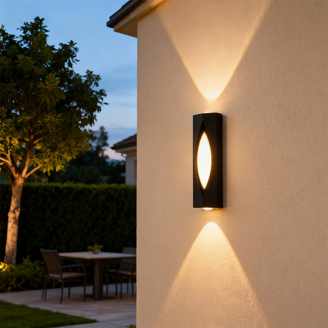 Architectural decorative wall sconce lighting featuring glass shade chandelier styling providing warm uplighting and downlighting at twilight.