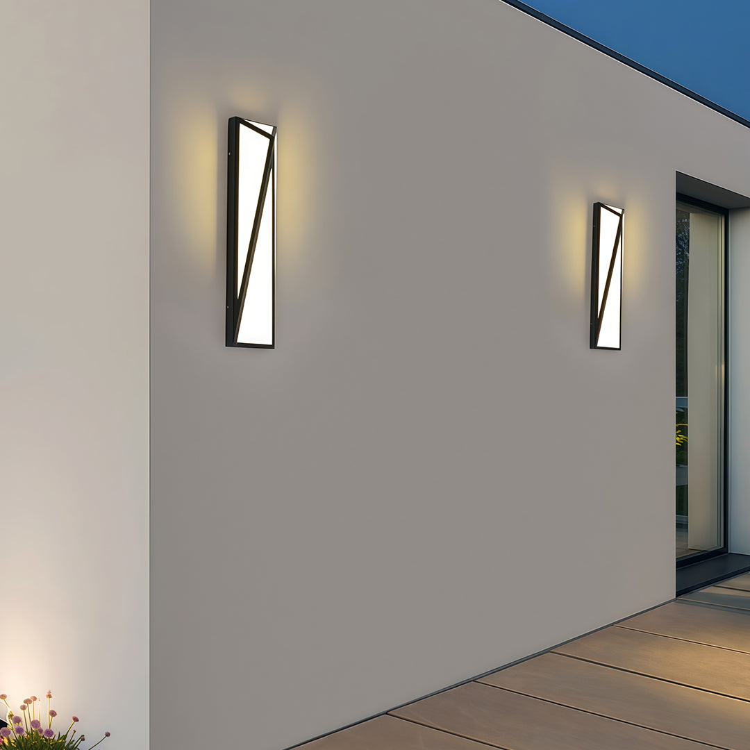 Architectural exterior wall light black with glass shade chandelier styling creating dramatic uplighting and downlighting in modern hallway.