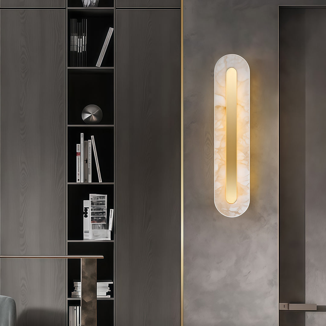 Architectural gold wall light featuring glass shade chandelier design illuminating modern office space with dark shelving and minimal decor.