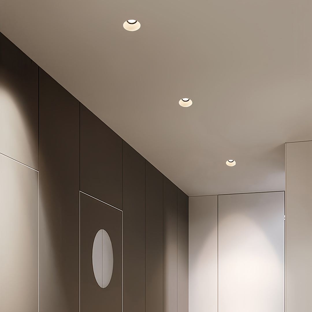 Architectural indoor LED spotlight featuring glass shade chandelier inspired design in modern corridor with clean lines.