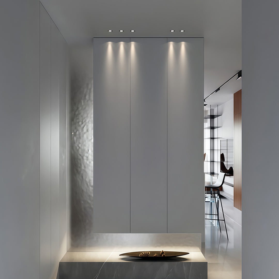 Architectural indoor spotlights in minimalist hallway featuring glass shade chandelier inspired accent lighting design.