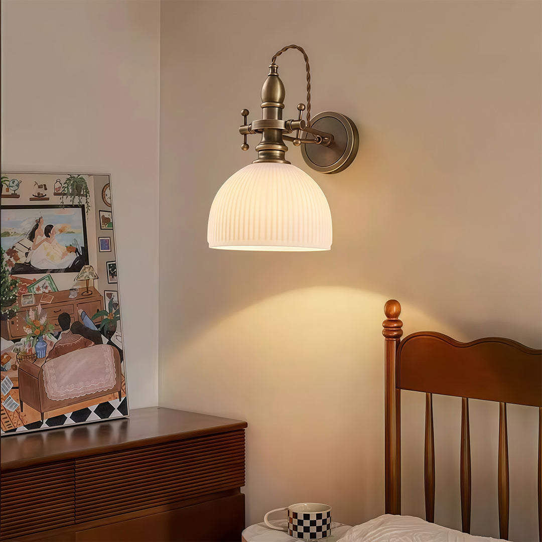 Architectural indoor wall mount lights with glass shade chandelier styling illuminating traditional bedroom with wood furniture.