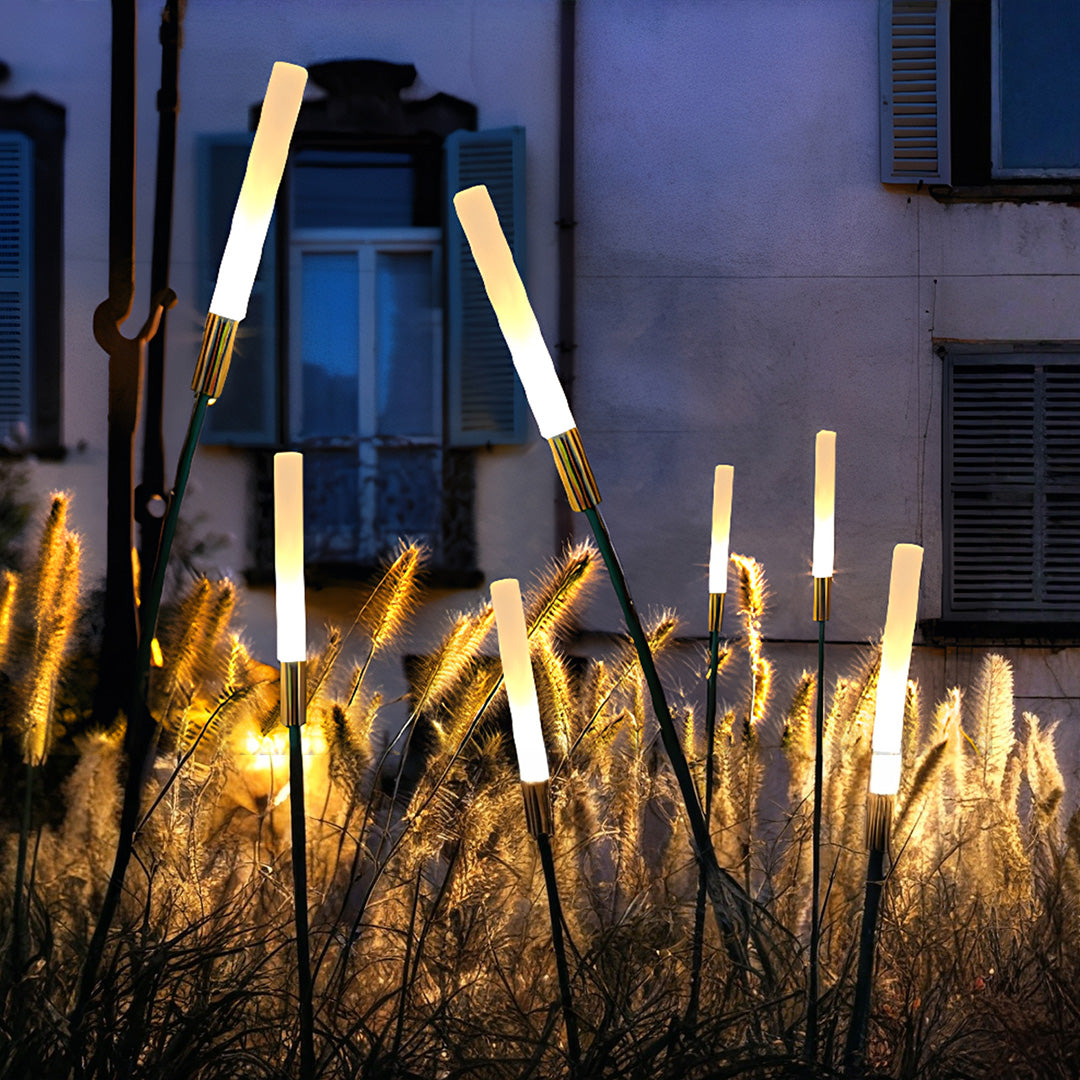 Architectural landscape spike light arrangement with warm glow enhancing contemporary building exterior lighting design