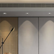 Architectural LED indoor spotlights with glass shade chandelier aesthetic highlighting modern entryway and wood paneling.