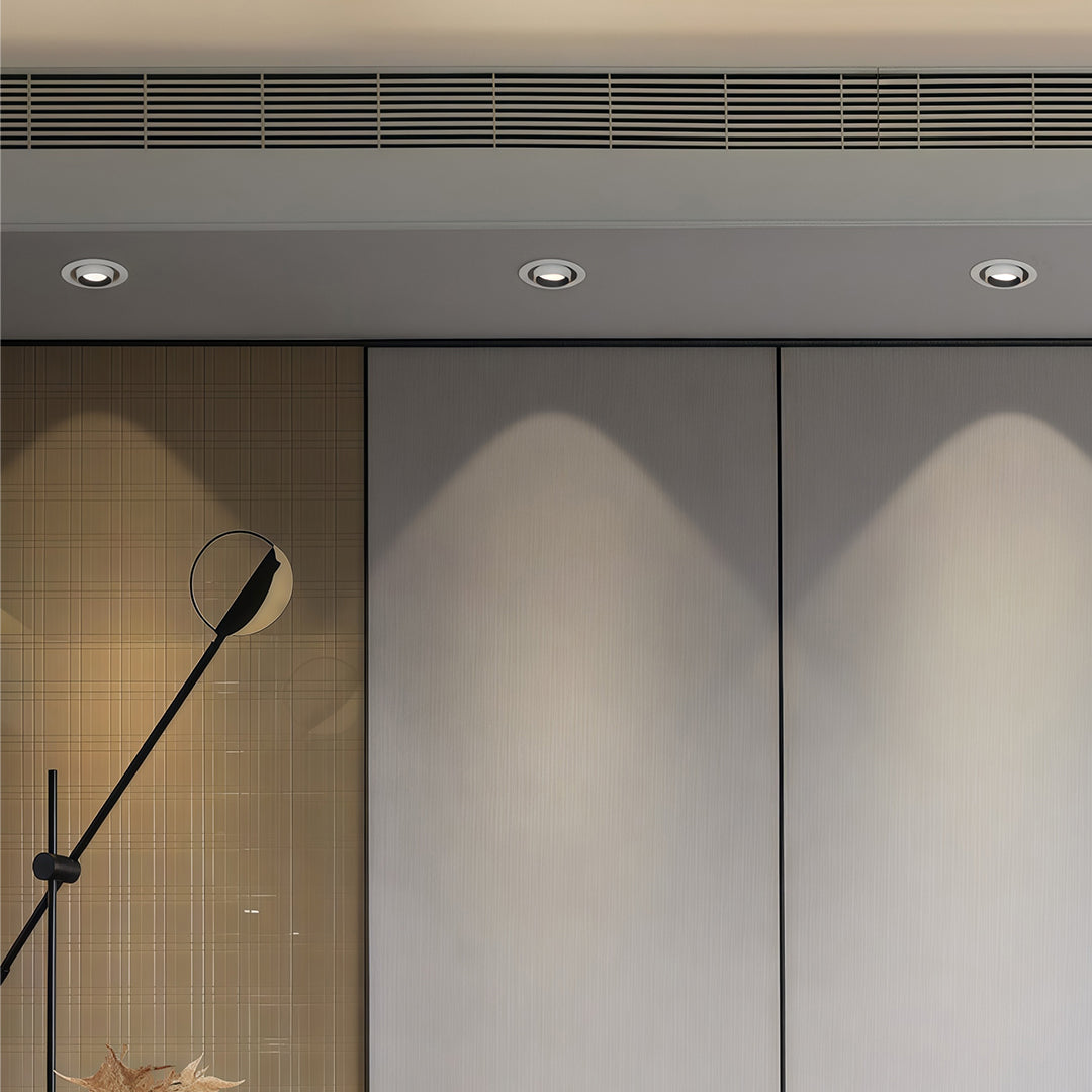 Architectural LED indoor spotlights with glass shade chandelier aesthetic highlighting modern entryway and wood paneling.