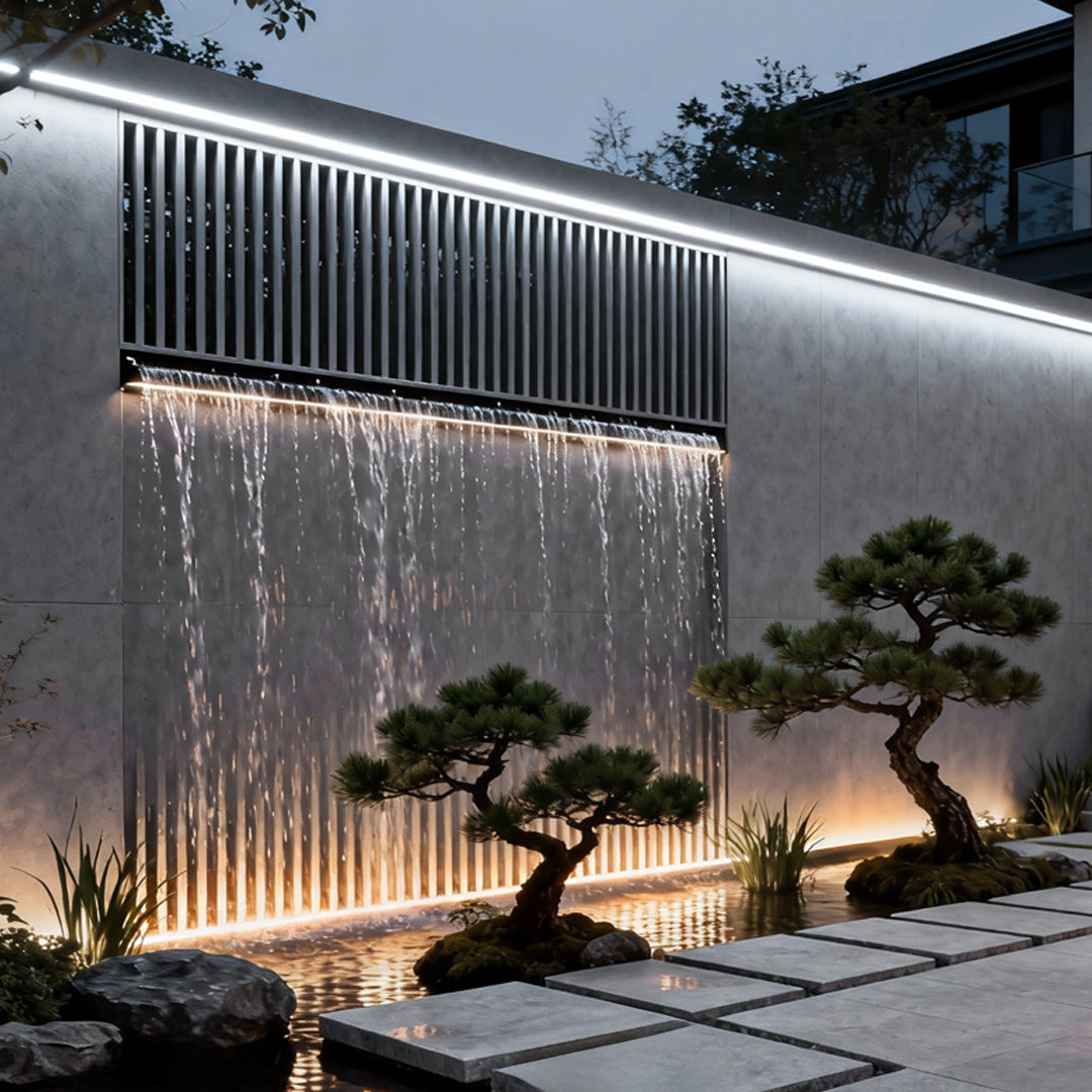 Architectural led strip lighting integrated into a water feature wall, producing elegant vertical and horizontal light effects.