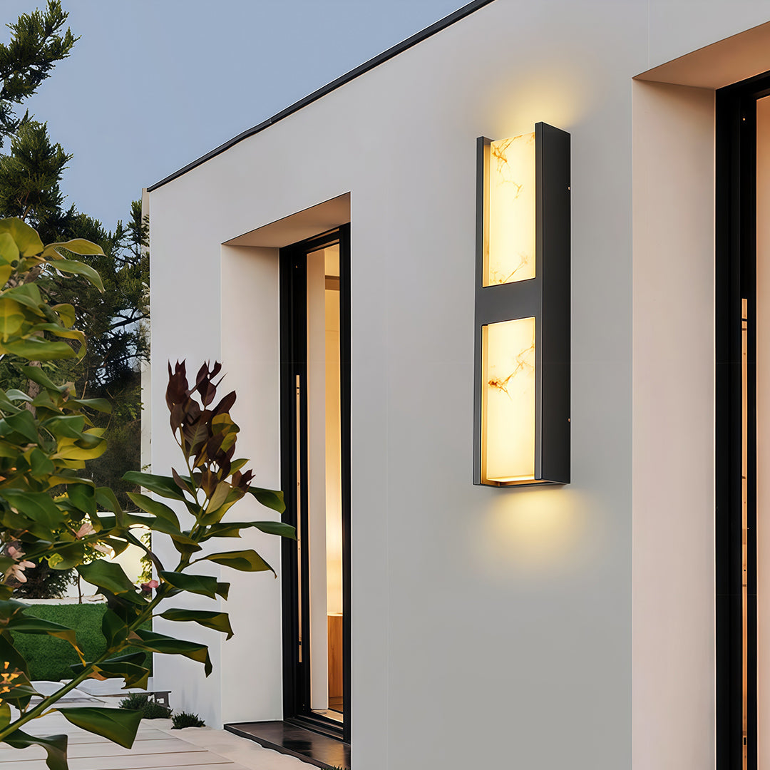 Architectural LED wall sconce light fixtures with glass shade chandelier styling providing ambient lighting on contemporary facade.