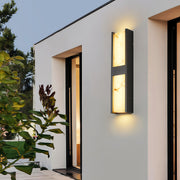 Architectural LED wall sconce light fixtures with glass shade chandelier styling providing ambient lighting on contemporary facade.