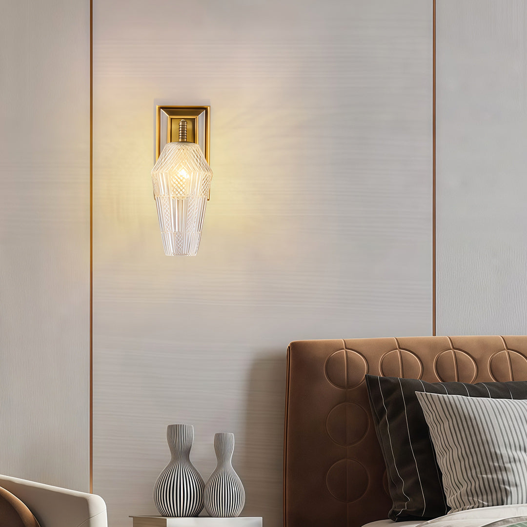 Architectural LED wall sconce lights featuring glass shade chandelier styling providing accent lighting above leather headboard.