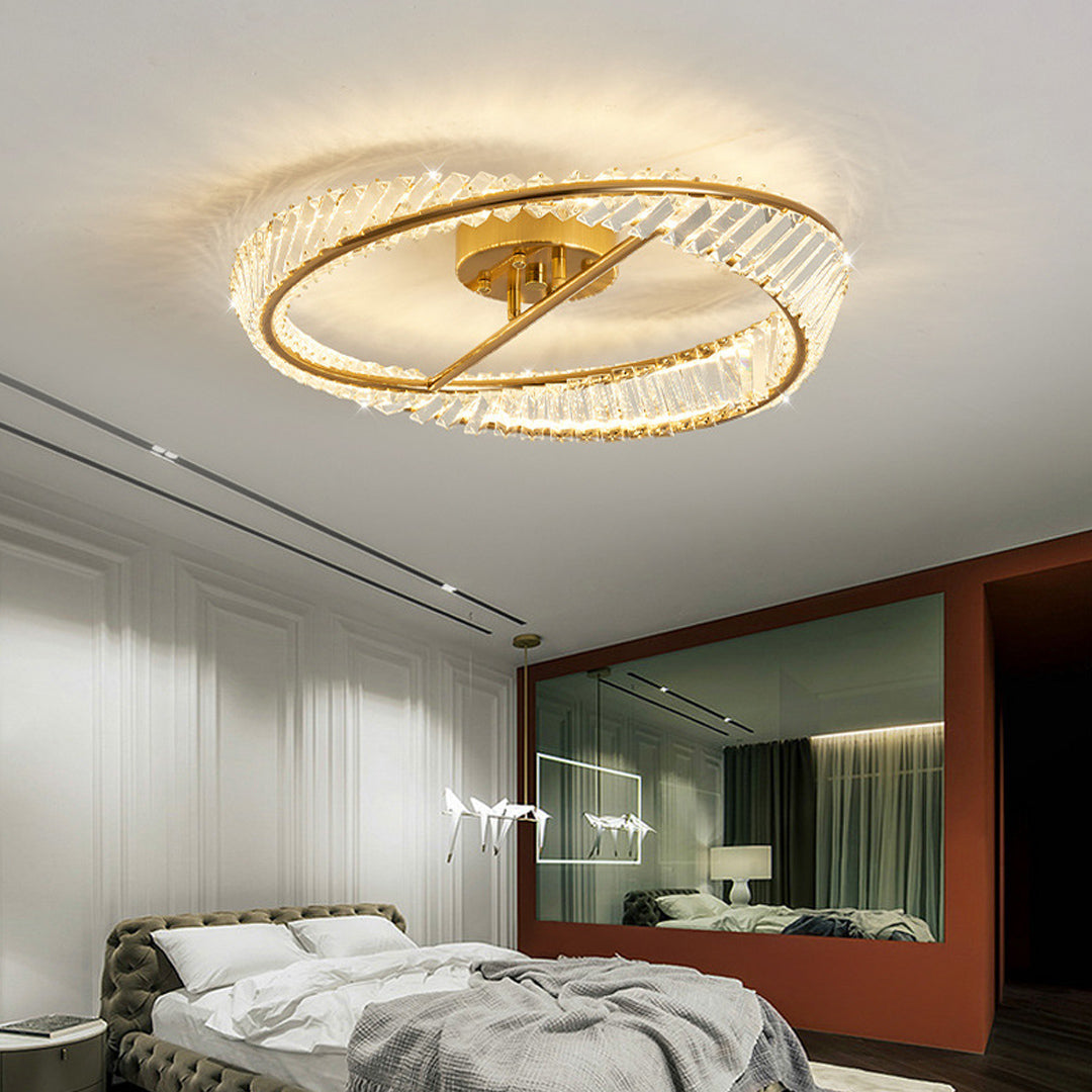 Architectural mobius light fixture with gold frame and crystal details in modern living space