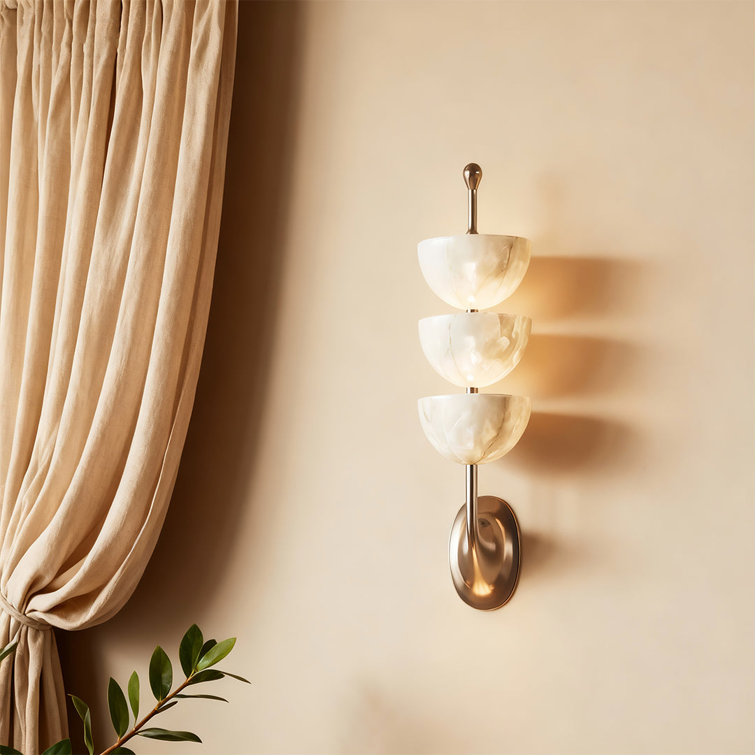 Architectural modern LED wall lights with glass shade chandelier aesthetic providing soft illumination beside flowing curtains.