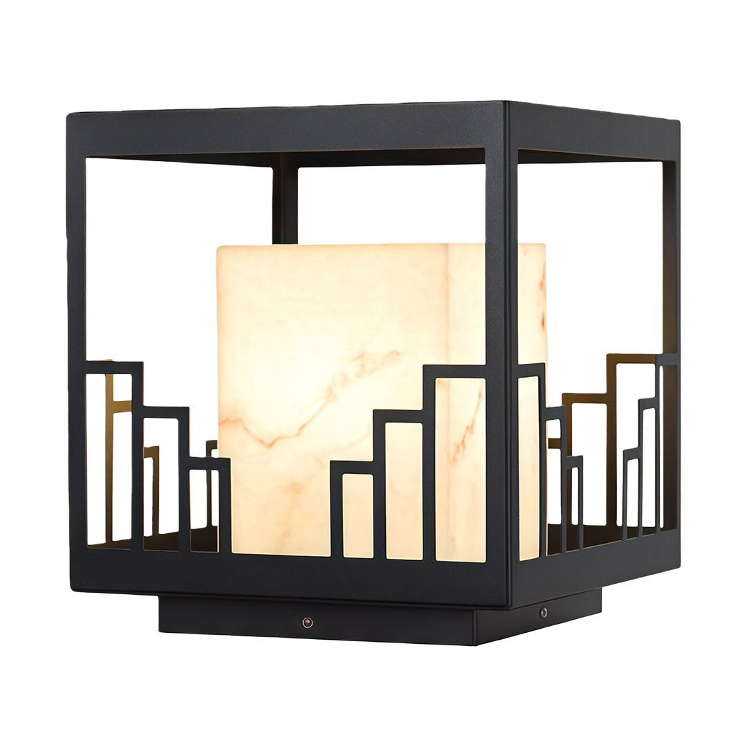Architectural outdoor pillar light with glass shade chandelier styling in lantern design with cityscape cutout and warm glow.