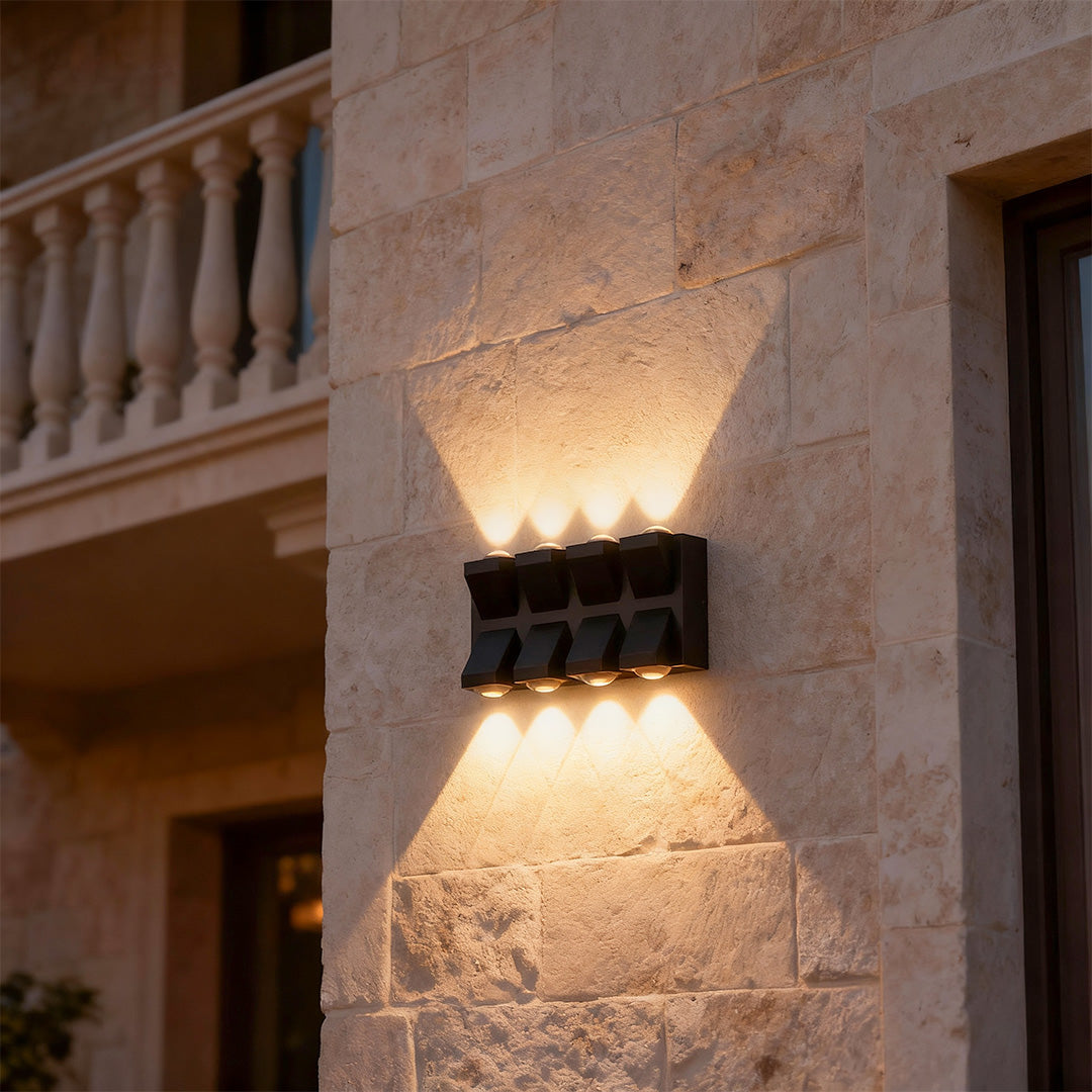 Architectural outdoor wall lights black featuring glass shade chandelier styling with dramatic light patterns on textured stucco.