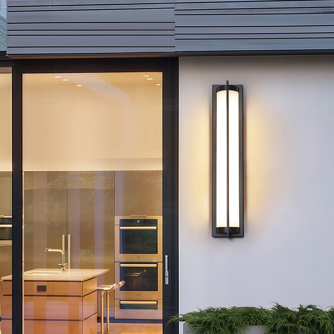 Architectural outdoor wall sconces black with glass shade chandelier styling illuminating contemporary home entrance at twilight.