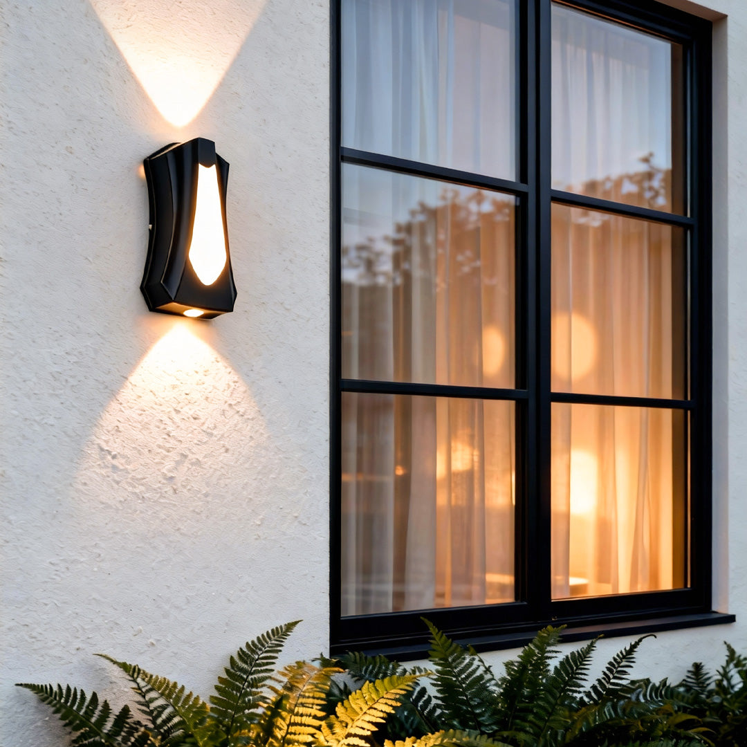 Architectural outside up down wall lights installed beside large windows, creating dramatic light patterns on the wall.