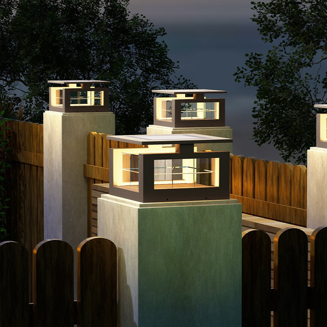 Modern architectural pillar lights with cubic design illuminating contemporary building columns at evening twilight