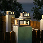Modern architectural pillar lights with cubic design illuminating contemporary building columns at evening twilight