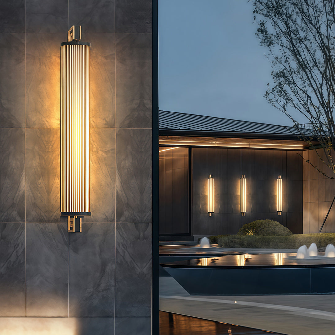 Architectural wall mounted linear lighting with glass shade chandelier styling providing dramatic accent lighting in modern wood-slat interior.