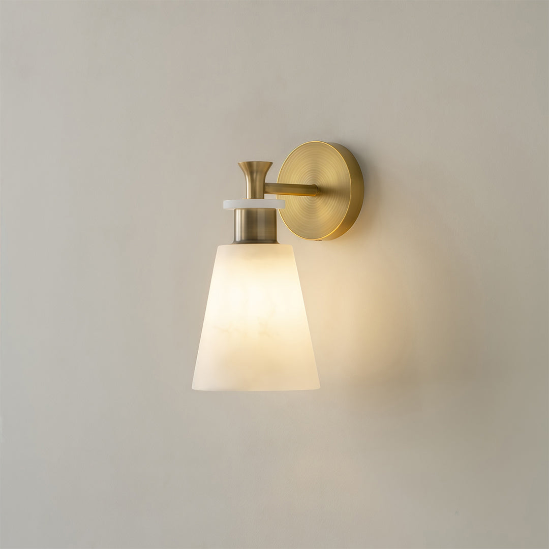 Architectural wall sconce LED light with glass shade chandelier styling providing soft downlighting on neutral wall surface.