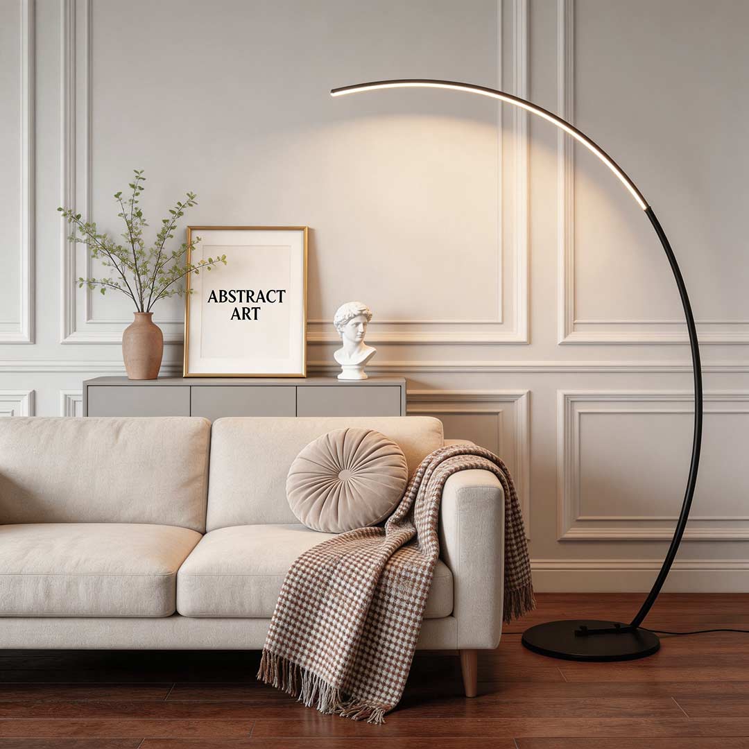 Black dimmable arc floor lamp illuminating a modern sofa reading area