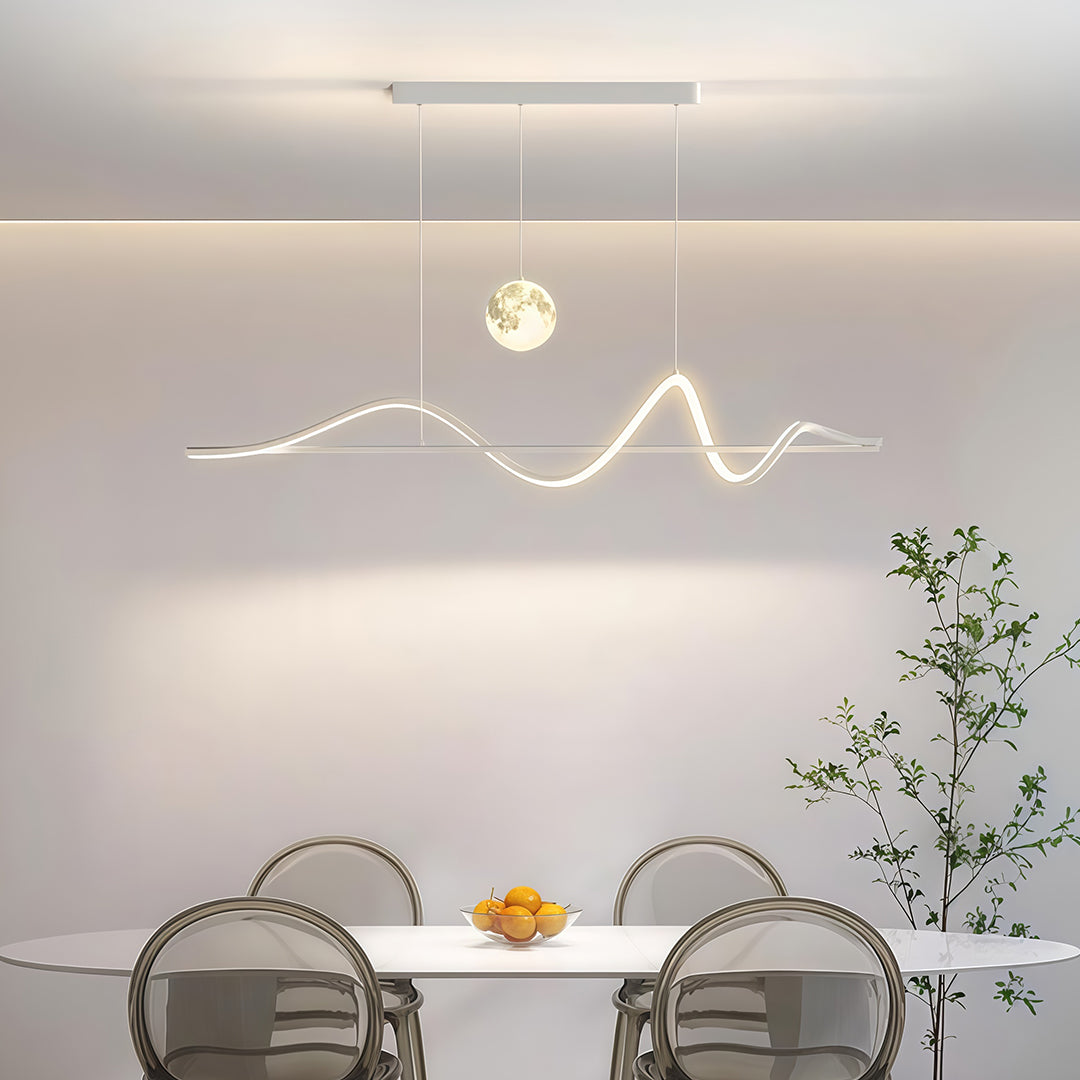 Art deco pendant light installed above beige dining table with decorative vase and neutral decor.
