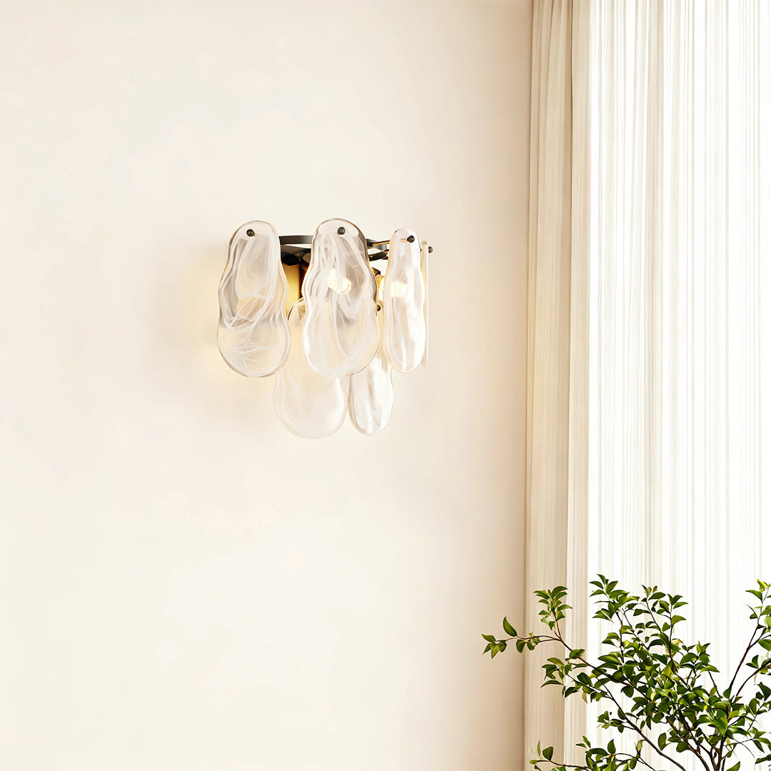 Art deco wall lights creating warm glow in bright room with natural light and greenery