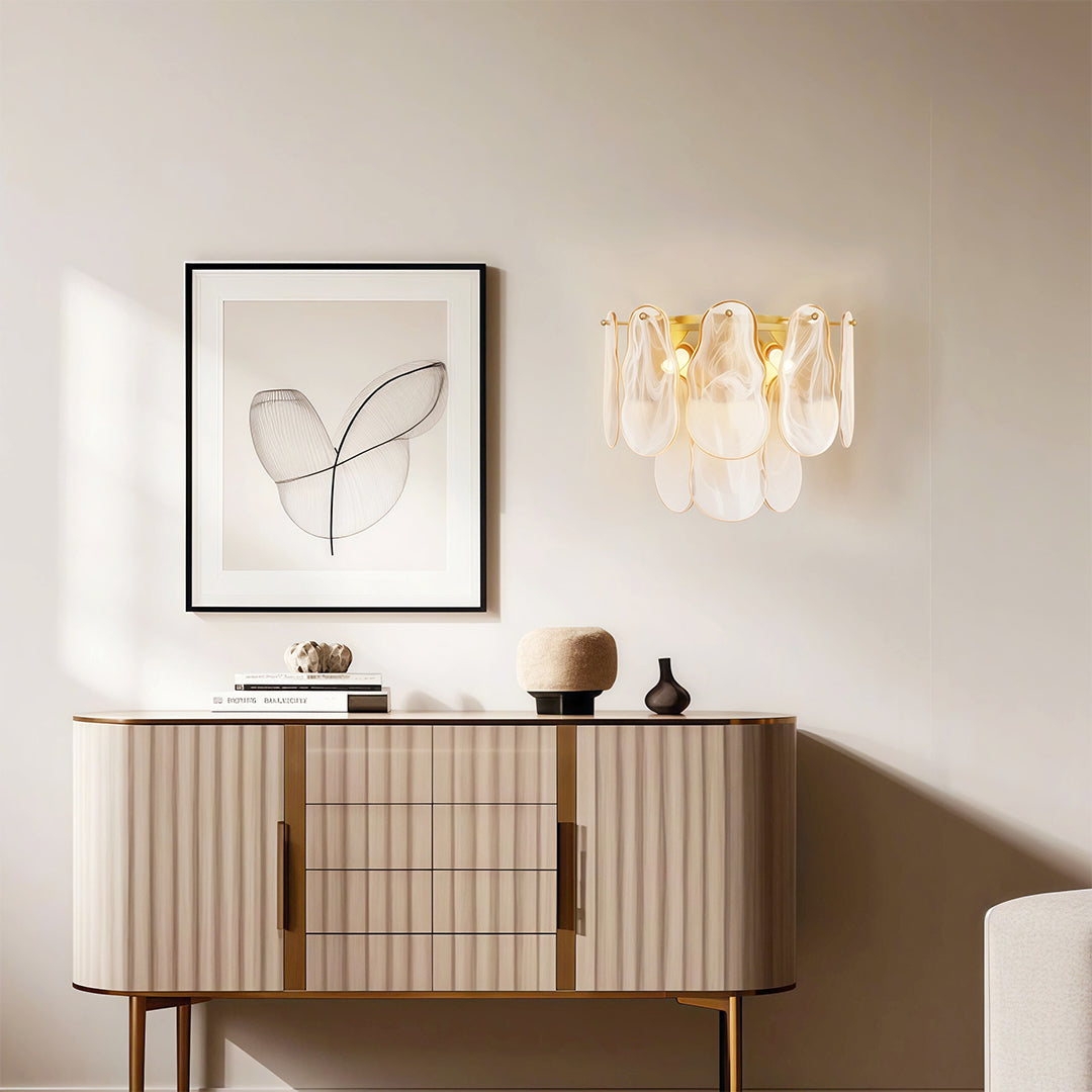 Art deco wall lights illuminating elegant console area with modern artwork and decorative vase