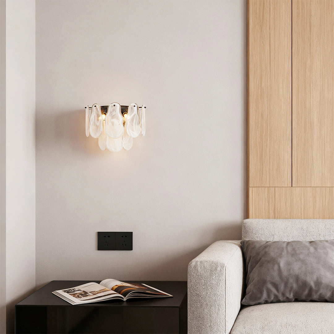 Art deco wall lights providing ambient lighting in modern bedroom with wooden accent wall