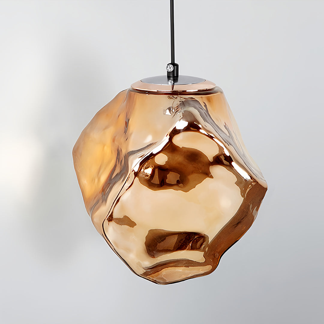 Art deco wall sconce lighting suspended on adjustable arm with faceted amber glass shade in modern setting