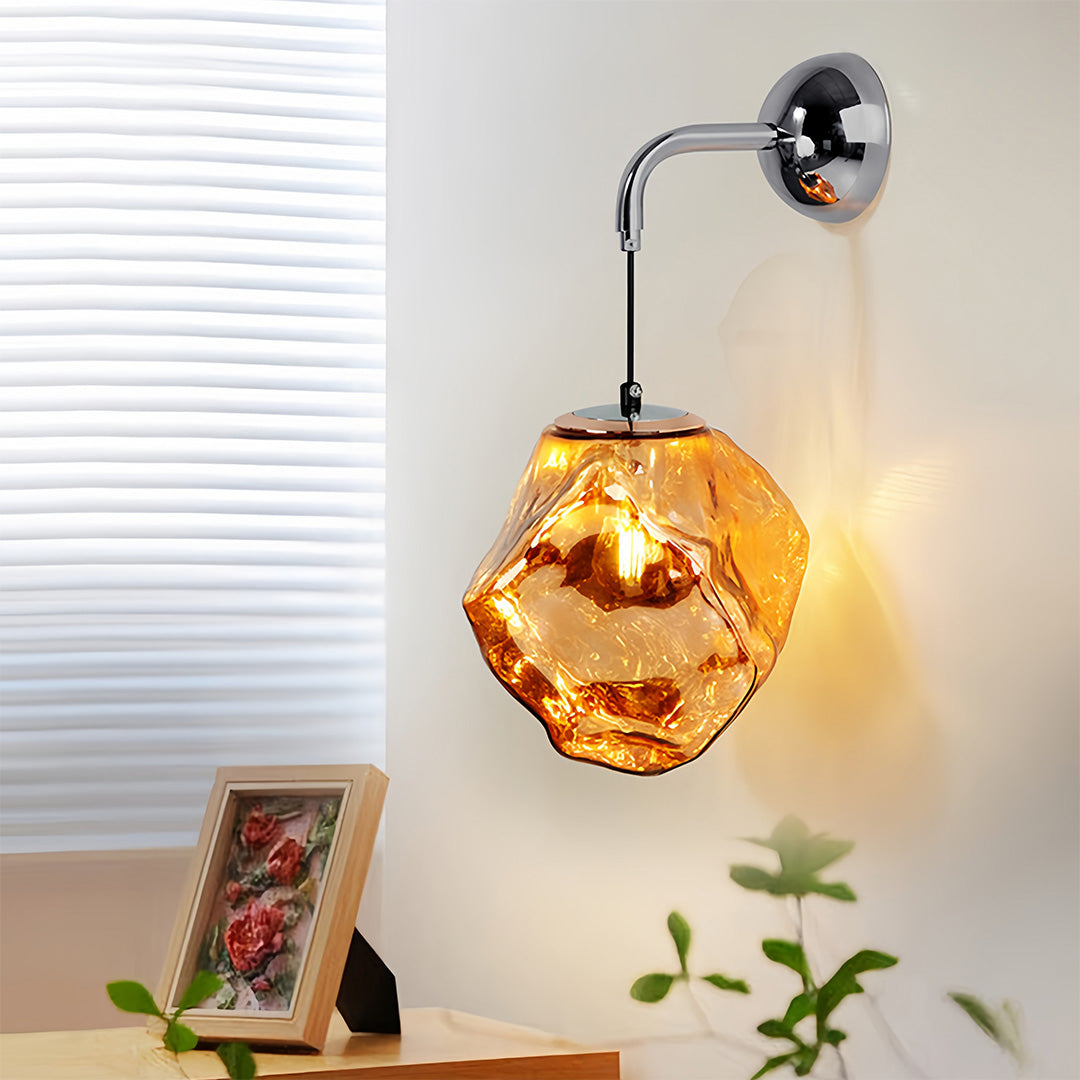 Art deco wall sconce lighting creating warm glow beside window with amber faceted glass shade