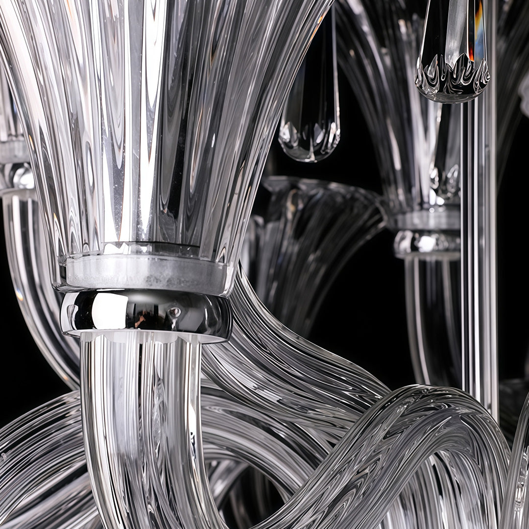 Art glass chandelier with clear crystals hanging in elegant black and white luxury bedroom setting.