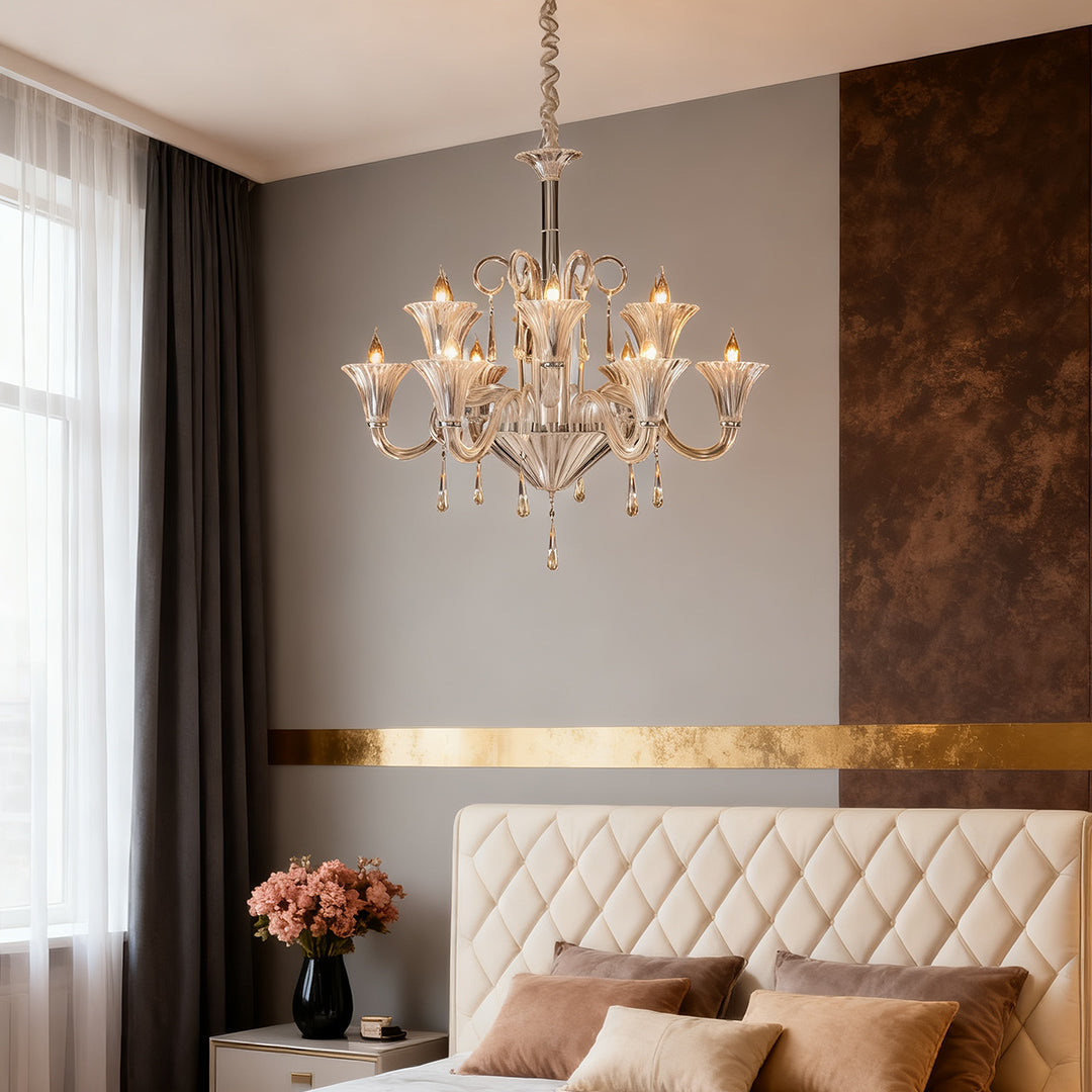 Art glass chandelier creating warm ambiance in modern bedroom with brown accent wall and upholstered headboard.