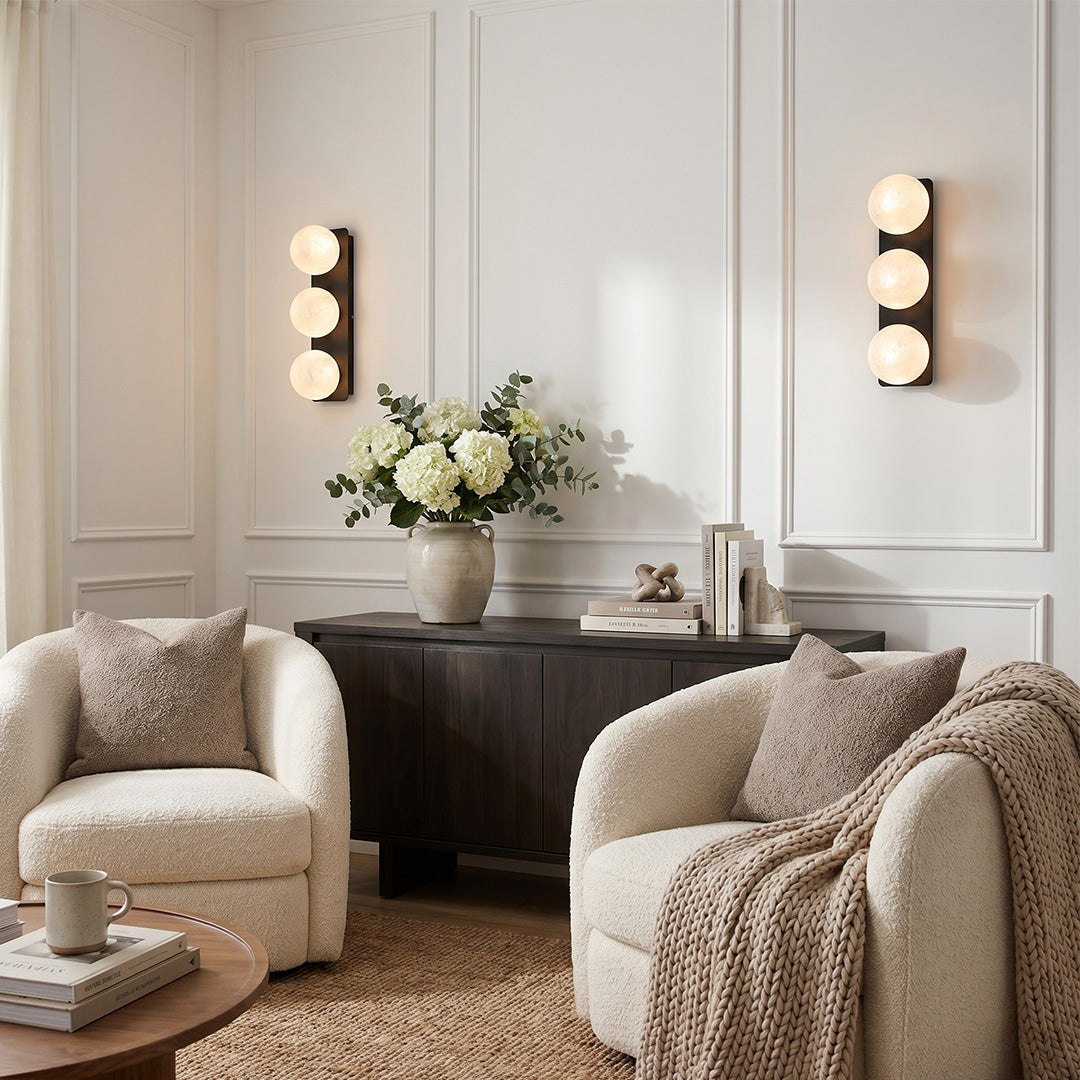 Art glass wall sconces in a cozy living room with soft ambient lighting.