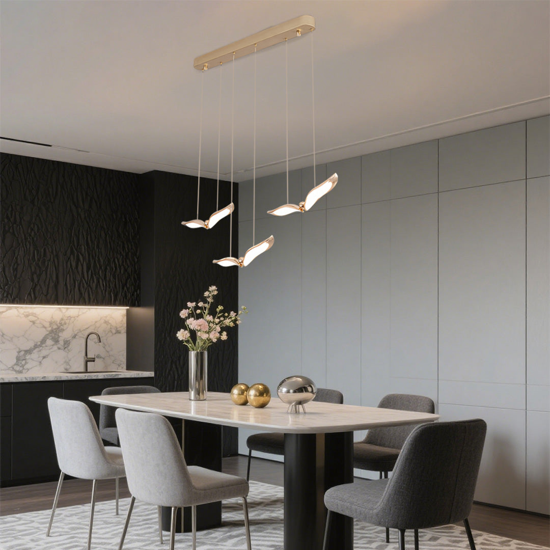 Art-inspired bird pendant light table adding sculptural elegance to upscale restaurant décor