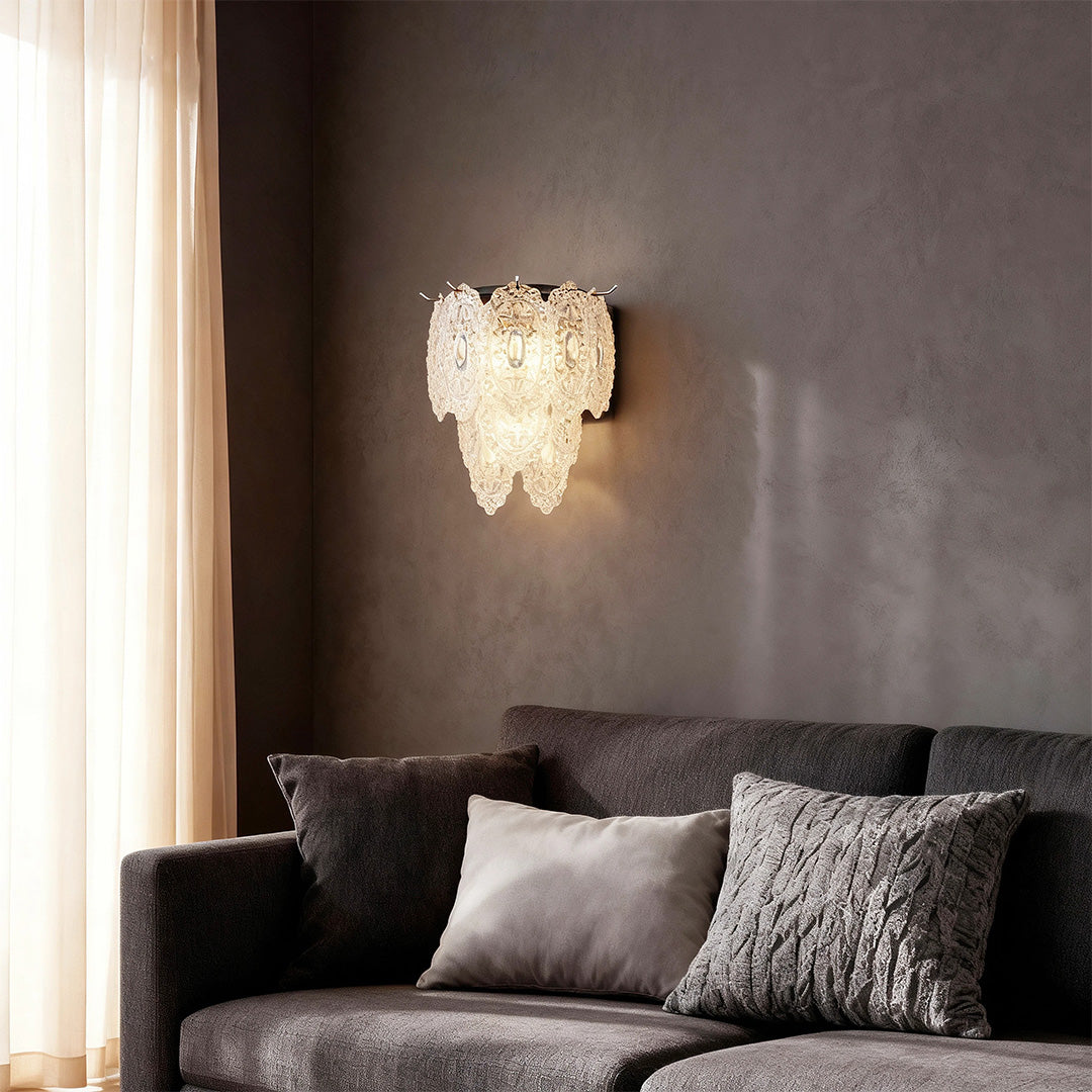 Art wall lights providing warm illumination above dark sofa in contemporary living room