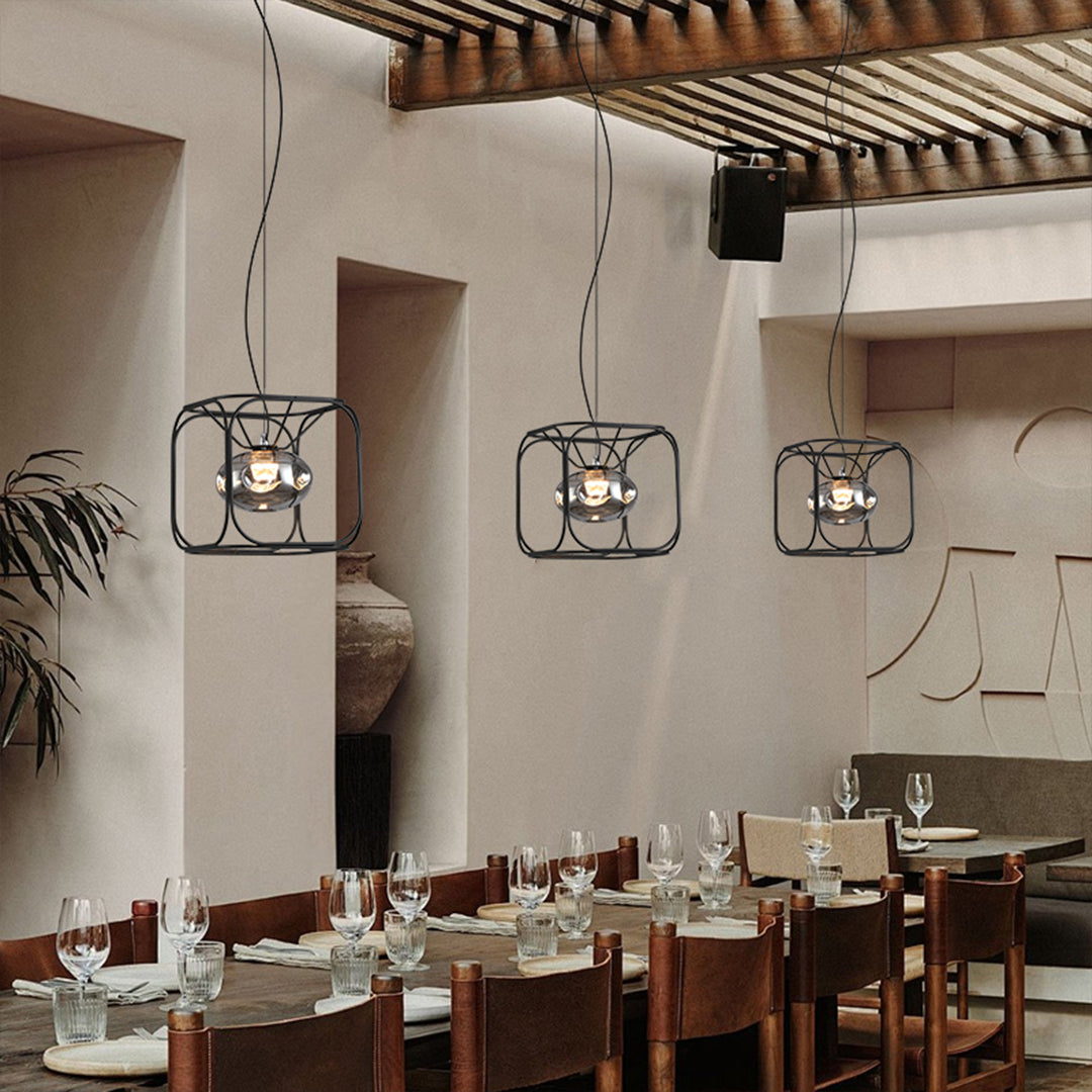 Artistic caged pendant light installation showing detailed wire construction and atmospheric lighting effects