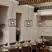 Artistic caged pendant light installation showing detailed wire construction and atmospheric lighting effects