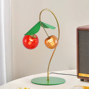 Artistic modern LED table lamps with cherry design positioned on contemporary workspace