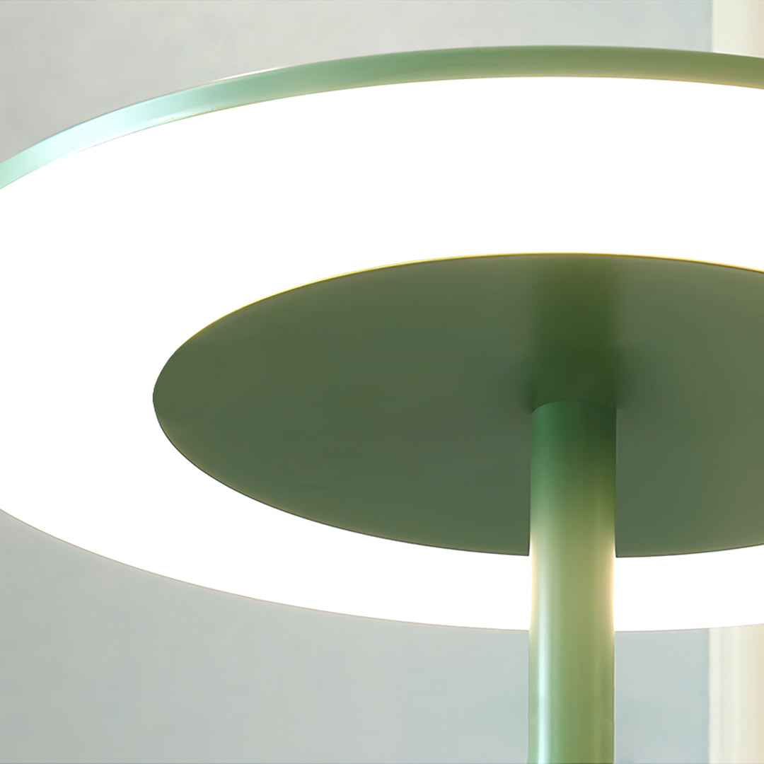 Artistic colored floor lamp with curved design elements creating dramatic lighting and shadow effects