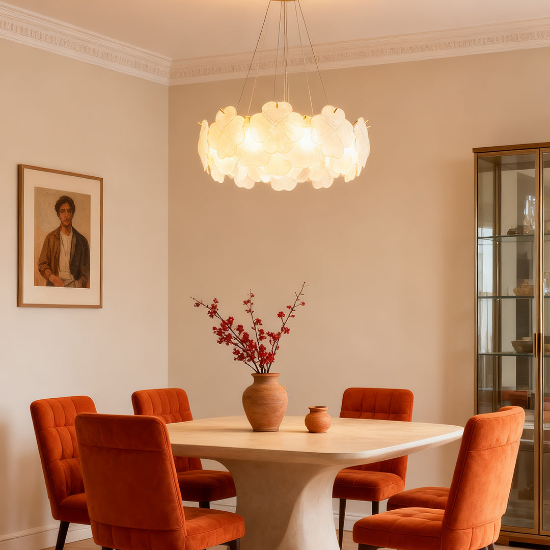 Artistic glass chandeliers installed in a dark-themed living room, providing a striking contrast and warm glow