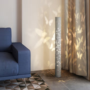 Artistic small black pendant light with decorative cutouts projecting intricate light designs