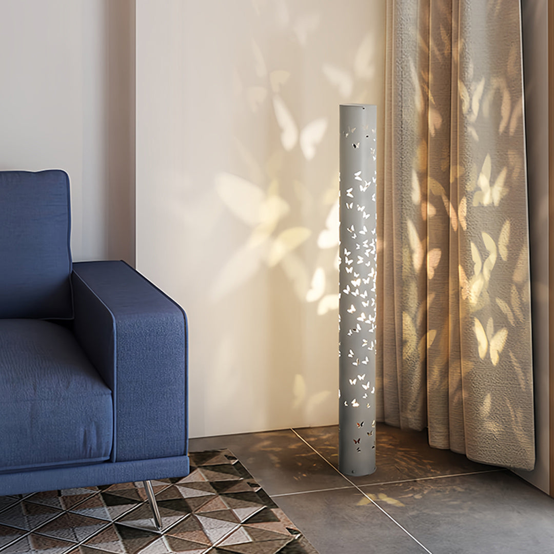 Artistic small black pendant light with decorative cutouts projecting intricate light designs