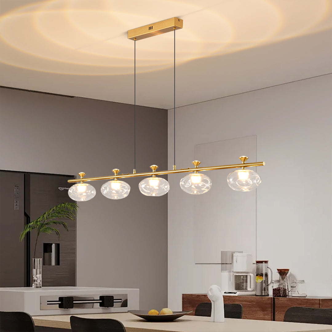 Artistic linear glass chandelier installation showcasing horizontal glass globe arrangement in modern kitchen