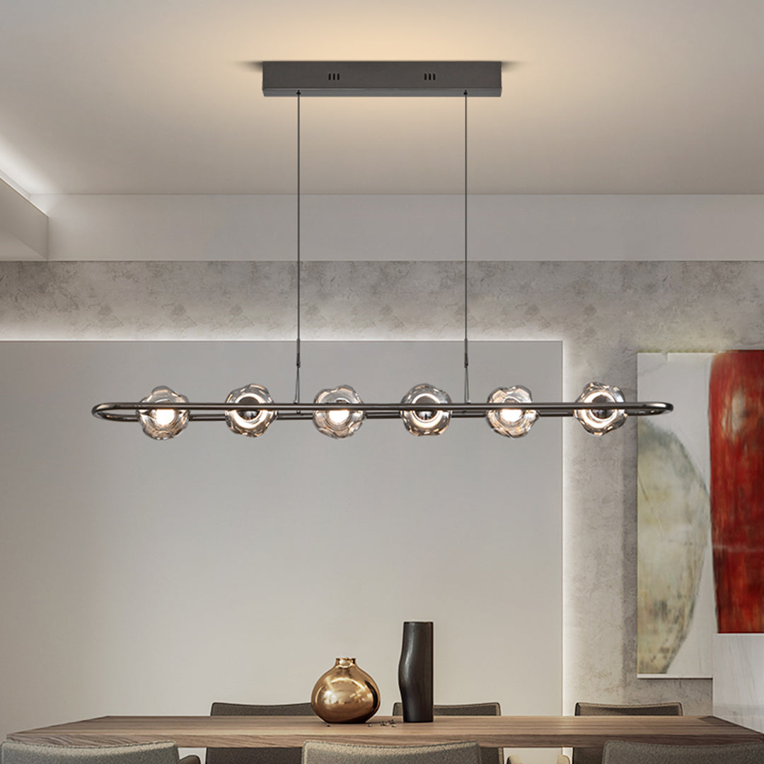 Artistic rise and fall pendant light installation showcasing linear glass globe arrangement in modern kitchen