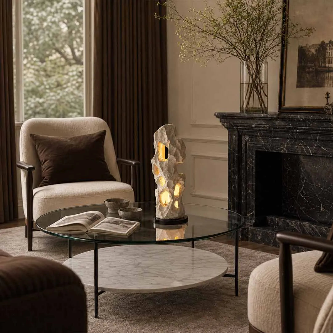 Artistic table lamps illuminating a sophisticated living room with a fireplace and lounge chair.